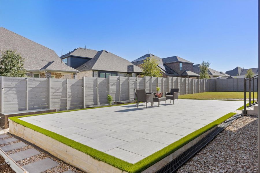 Fenced backyard with a patio and a residential view Fenced backyard with a patio and a residential view