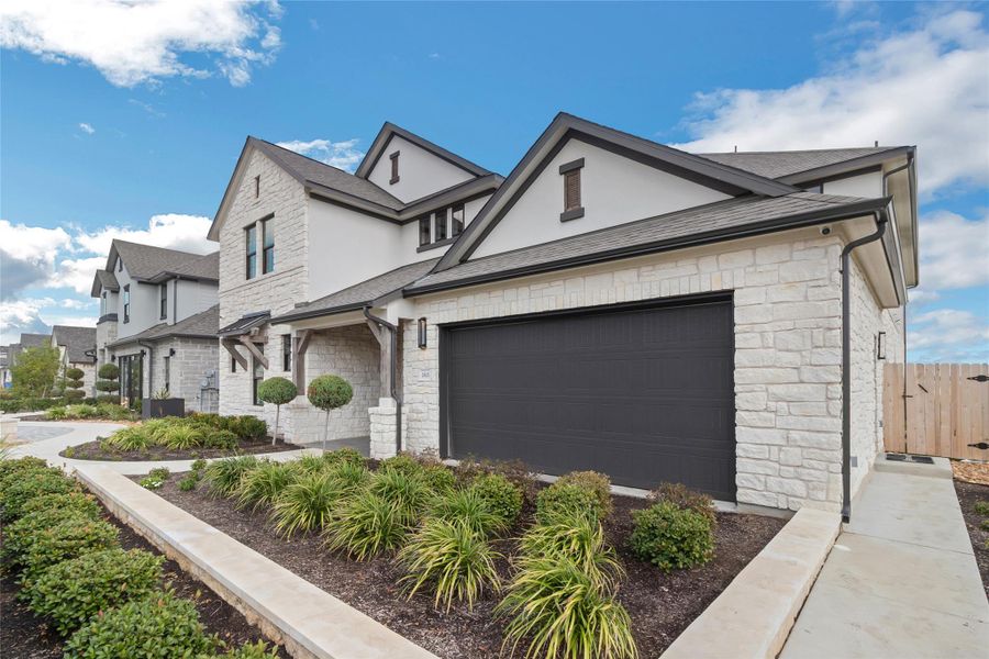 View of front of home with stone siding, stucco siding, and roof with shingles View of front of home with stone siding, stucco siding, and roof with shingles
