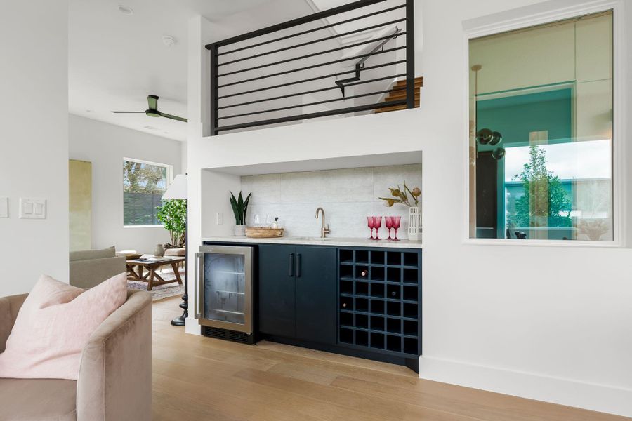 Wet bar with beverage fridge and wine bottle cubbies