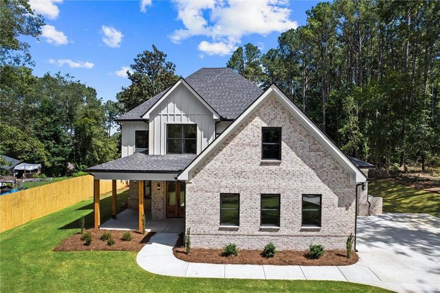 Front exterior of a new home in , Winder, GA, highlighting curb appeal (Image 26). Front exterior of a new home in , Winder, GA, highlighting curb appeal (Image 26).