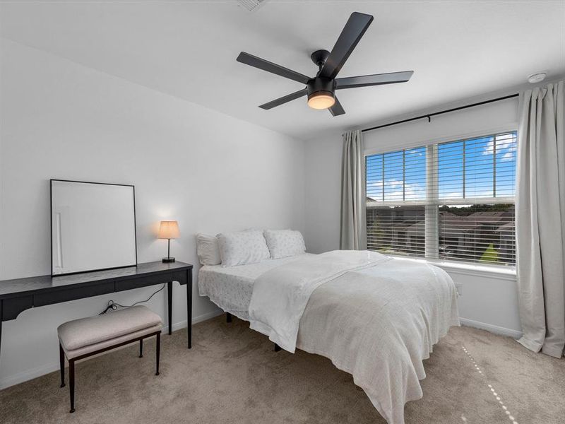 Your secondary bedroom features plush carpet, fresh paint, ceiling fan, and a large window that lets in plenty of natural lighting.