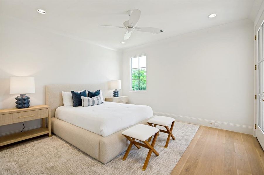 Recessed lighting with a ceiling fan, a window with exterior greenery, and wood-finish flooring