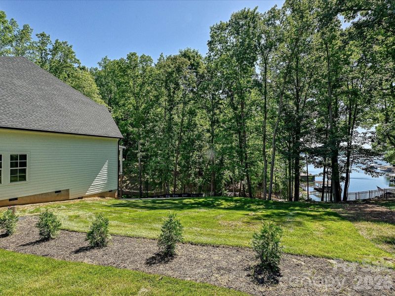 Peaceful, tranquil side/back yard leading down to the dock.