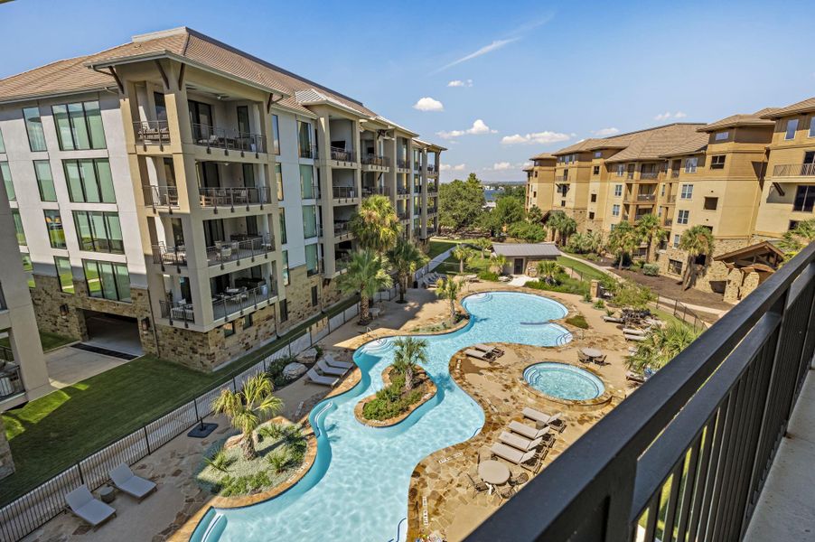 A luxury apartment community with a winding river-style pool, multiple relaxation zones, and spacious balconies for elevated outdoor living.