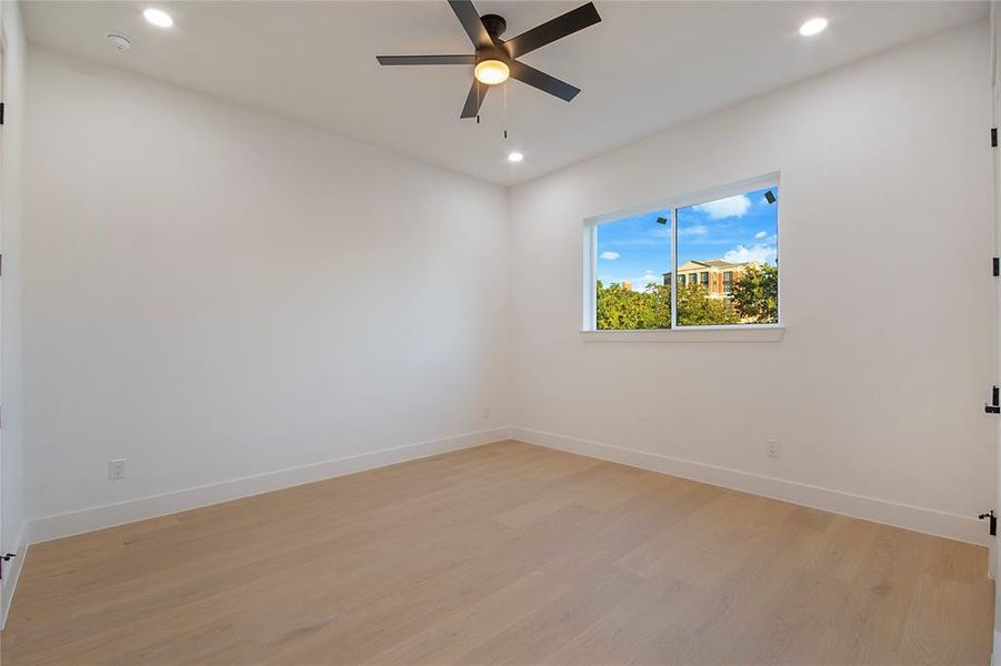 Empty room featuring light wood-style floors, recessed lighting, and a ceiling fan