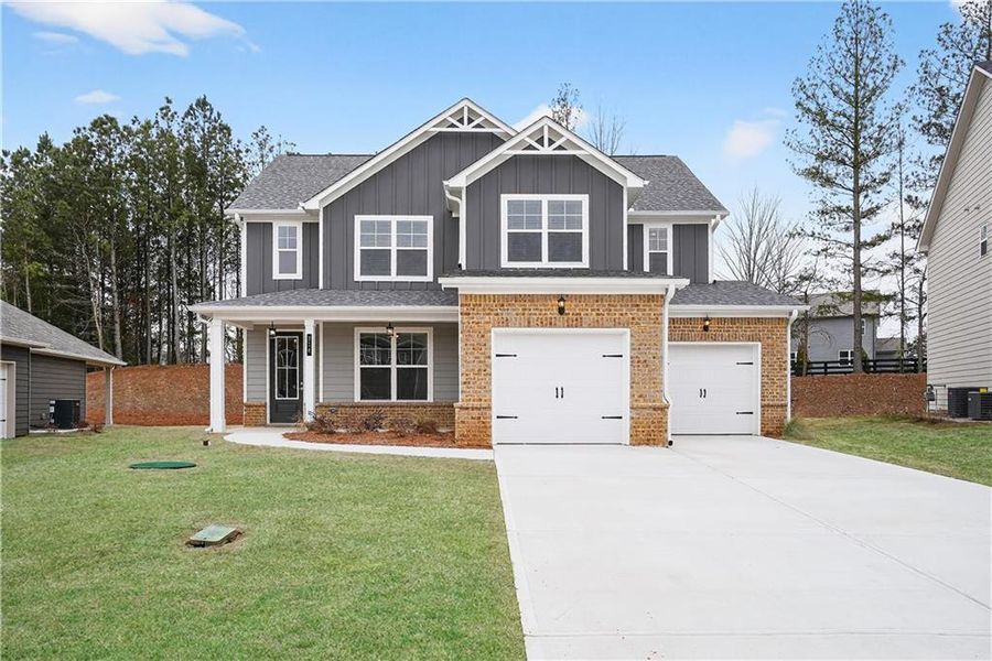 Front exterior of a new home in The Fairways at Mirror Lake, Villa Rica, GA, highlighting curb appeal (Image 1). Front exterior of a new home in The Fairways at Mirror Lake, Villa Rica, GA, highlighting curb appeal (Image 1).