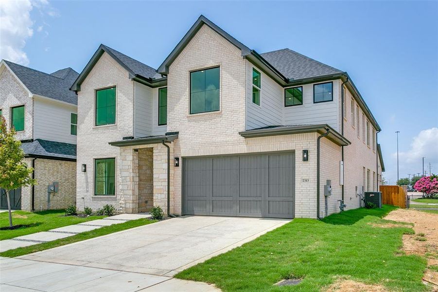 View of front of house with a garage, concrete driveway, and brick siding View of front of house with a garage, concrete driveway, and brick siding