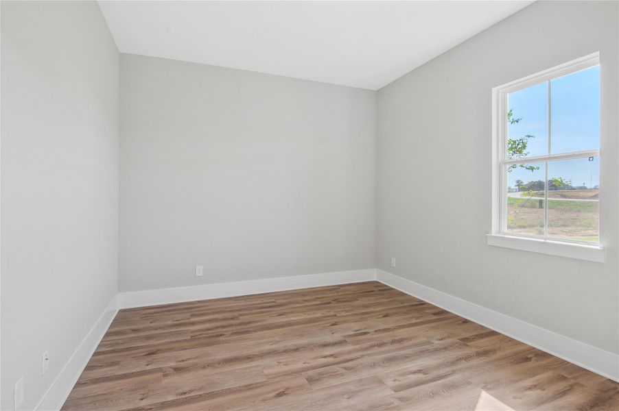 Bright and cozy bedroom with beautiful flooring and a serene view. Bright and cozy bedroom with beautiful flooring and a serene view.