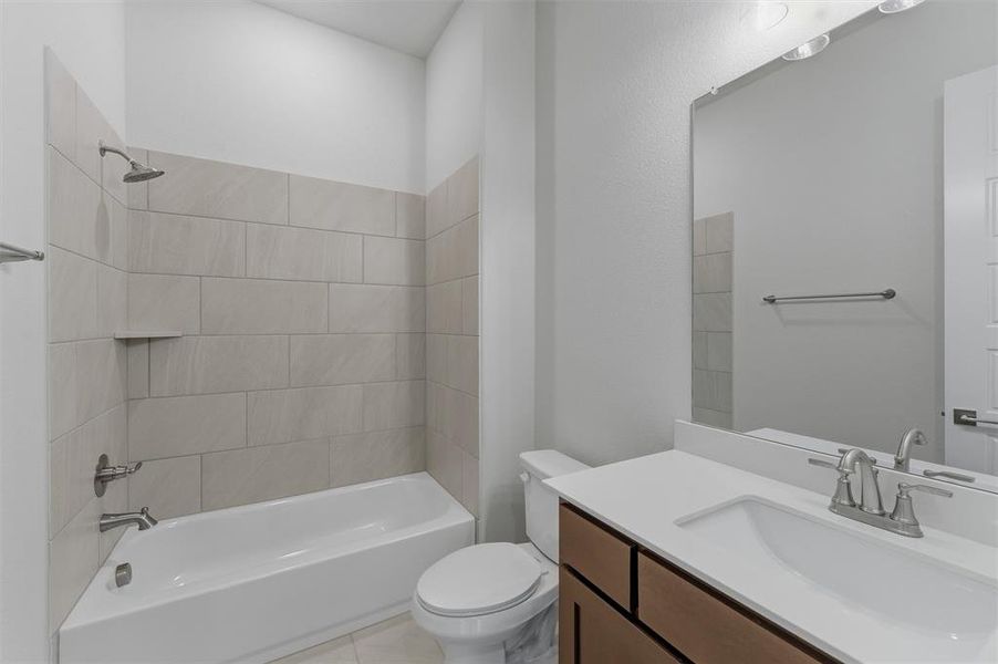 Bathroom featuring a single vanity with wood-finish cabinetry, a white countertop, and an integrated sink