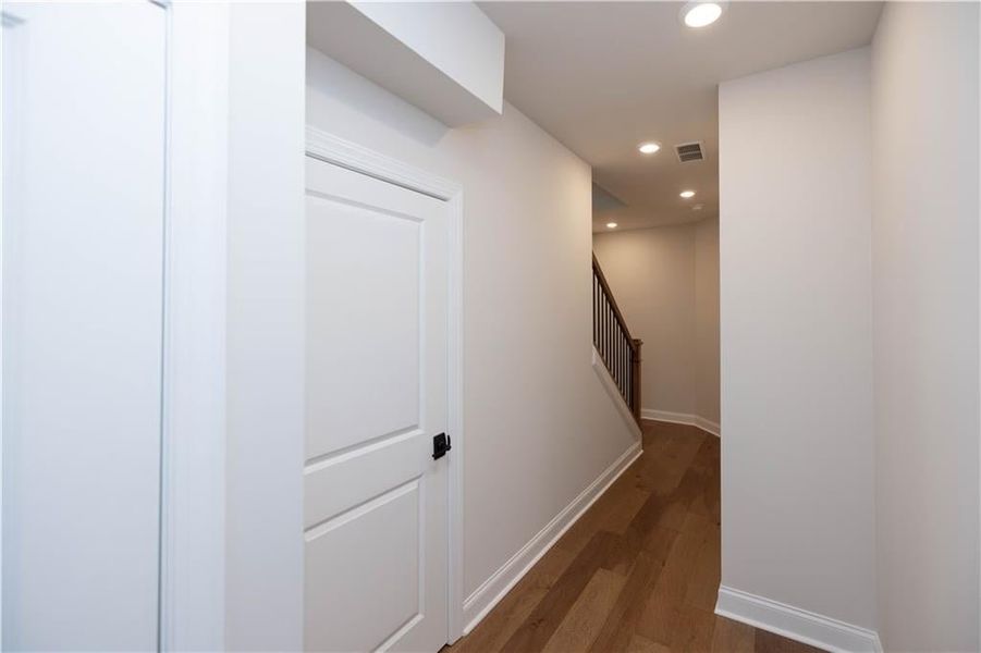 Hall featuring dark wood-type flooring