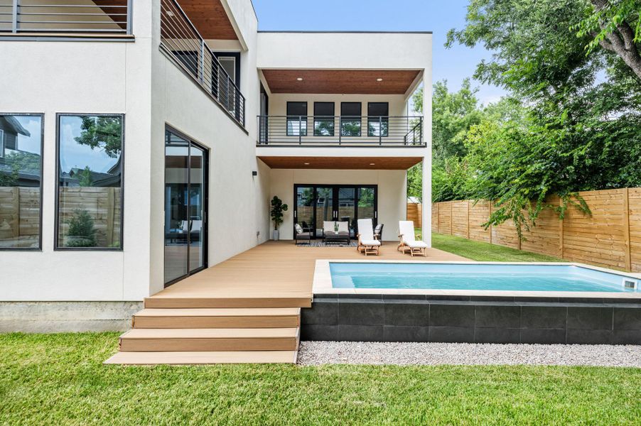 Modern architecture meets outdoor leisure with a sleek private pool and expansive wood deck. Modern architecture meets outdoor leisure with a sleek private pool and expansive wood deck.