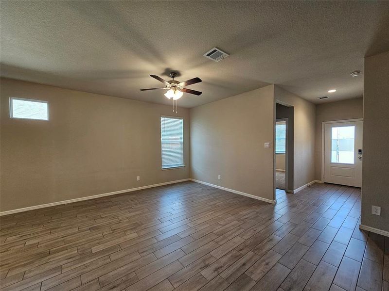 Entry and living room area featuring wood looking tile tile floors.