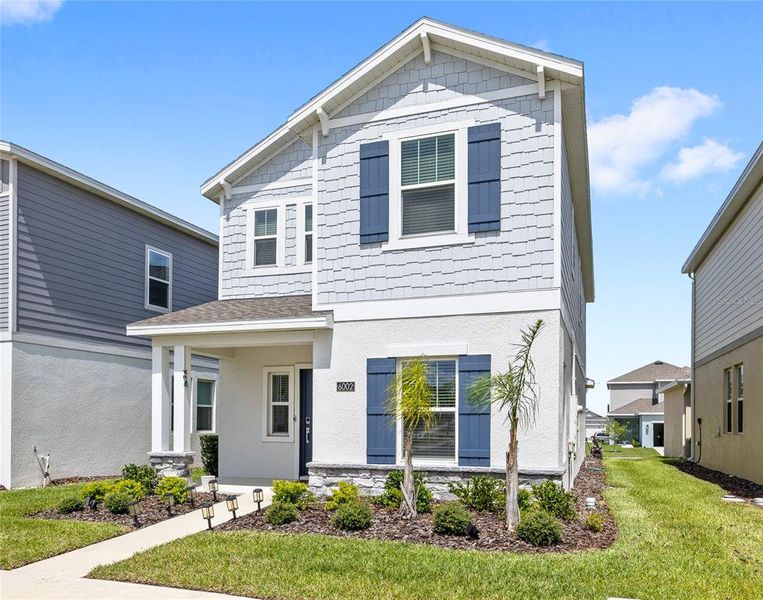 Front exterior of a new home in Wellness Ridge, Clermont, FL, highlighting curb appeal (Image 26).