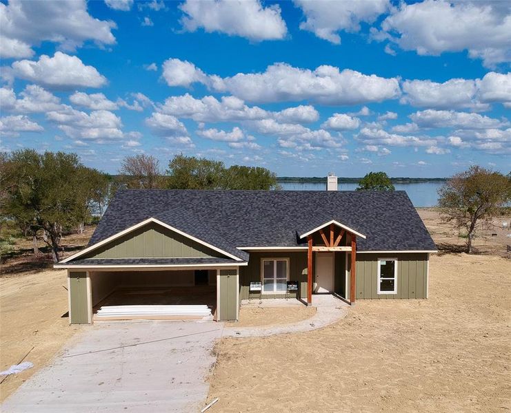 Ranch-style house featuring a water view