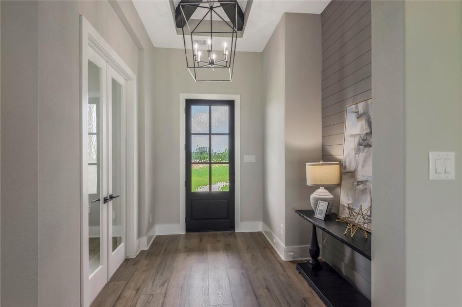 Entryway featuring sleek wood flooring and neutral walls, creating a warm, welcoming atmosphere. Entryway featuring sleek wood flooring and neutral walls, creating a warm, welcoming atmosphere.