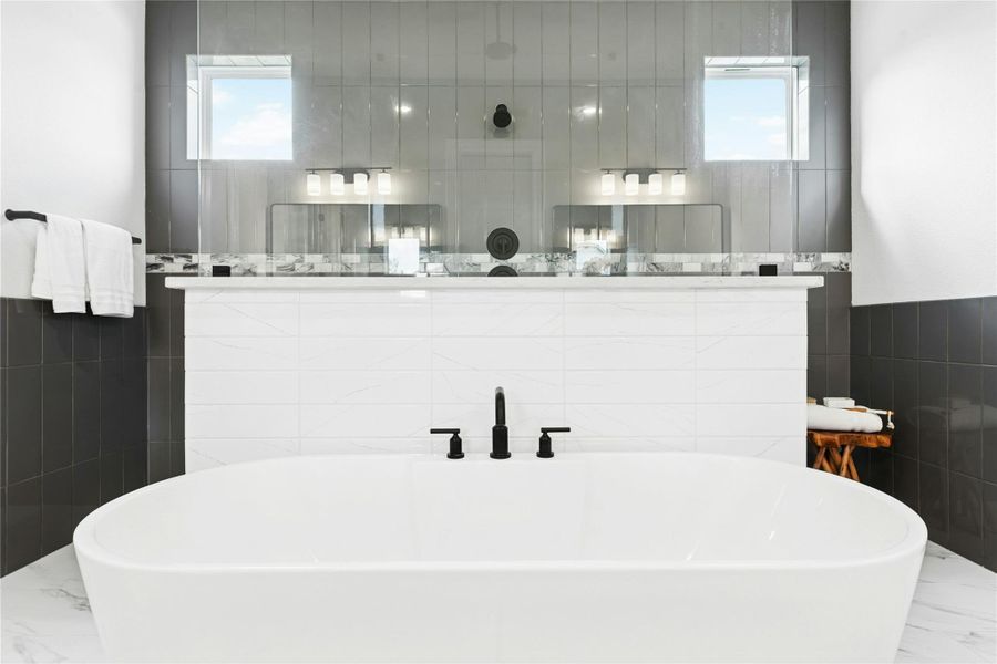 The primary bathroom features a large walk-in shower with a mud-set floor and tile walls, along with a freestanding soaking tub for a true spa-like experience. The primary bathroom features a large walk-in shower with a mud-set floor and tile walls, along with a freestanding soaking tub for a true spa-like experience.