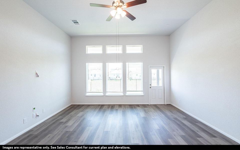 Spacious family room showcasing soaring ceilings, expansive windows, and beautiful flooring that fills the space with natural light, creating a warm and welcoming atmosphere for everyday living and entertaining. **Photos are representative only and may vary as built.** Spacious family room showcasing soaring ceilings, expansive windows, and beautiful flooring that fills the space with natural light, creating a warm and welcoming atmosphere for everyday living and entertaining. **Photos are representative only and may vary as built.**