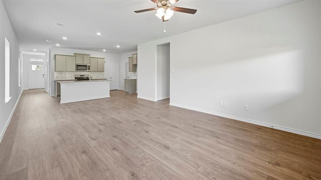 Unfurnished living room featuring recessed lighting, light wood finished floors, and a ceiling fan