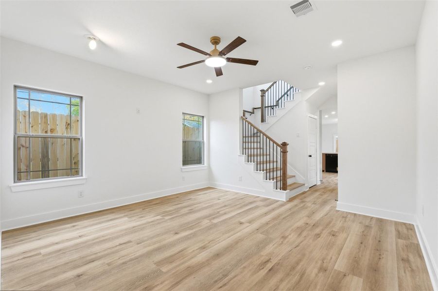 Come on in to meet your massive living area! Complete with a ceiling fan, recessed lights, and luscious luxury vinyl flooring.