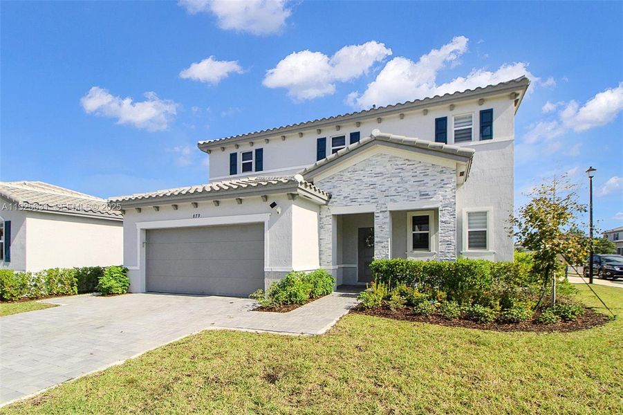 Front exterior of a new home in , Homestead, FL, highlighting curb appeal (Image 24). Front exterior of a new home in , Homestead, FL, highlighting curb appeal (Image 24).