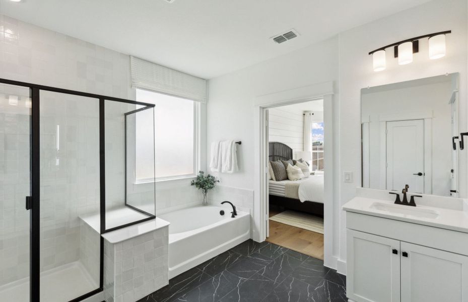 Owner's bath with separate vanities