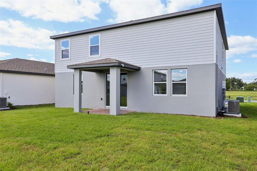Exterior details and patio area of a home in The Reserve at Twin Lakes, St. Cloud (Image 3).