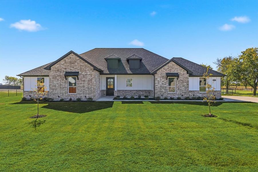 Front exterior of a new home in , Sanger, TX, highlighting curb appeal (Image 1).