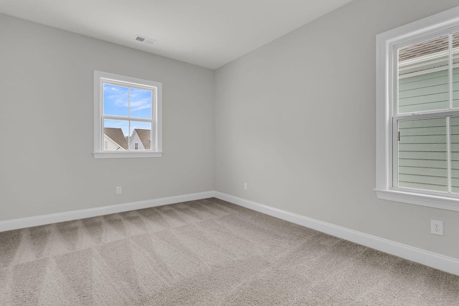 Spacious, unfurnished interior of a new home in Tidewater at Lakes of Cane Bay, Summerville (Image 41).