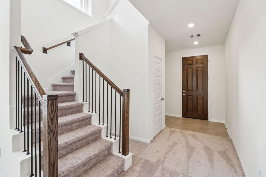 The entryway is bright and spacious while the staircase leads you to the 2nd floor bedrooms and bathrooms.