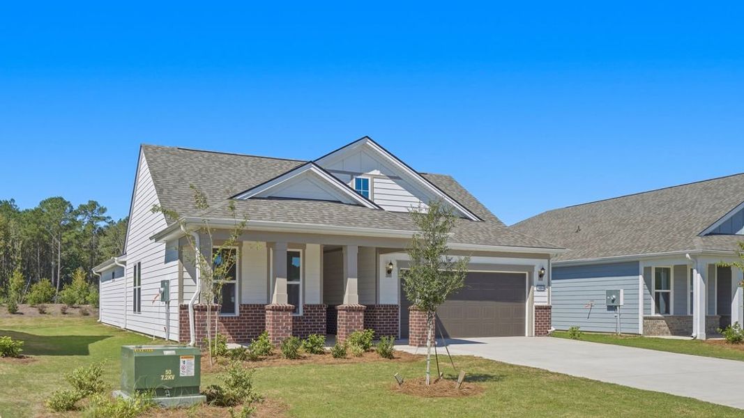 Front exterior of a new home in Sun City Hilton Head, Bluffton, SC, highlighting curb appeal (Image 21). Front exterior of a new home in Sun City Hilton Head, Bluffton, SC, highlighting curb appeal (Image 21).