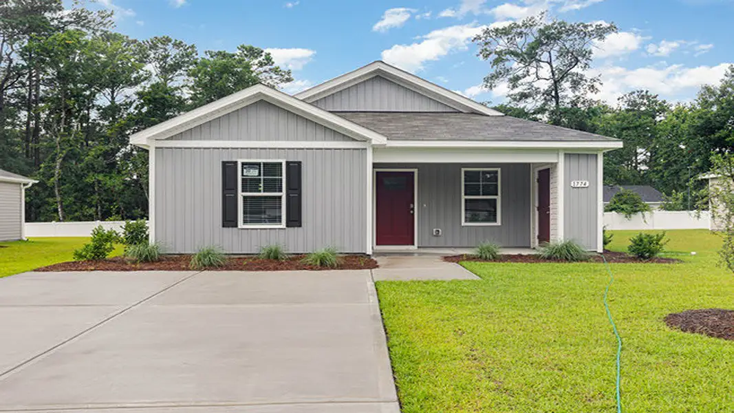 Front exterior of a new home in Sutton Farm, Loris, SC, highlighting curb appeal (Image 2). Front exterior of a new home in Sutton Farm, Loris, SC, highlighting curb appeal (Image 2).
