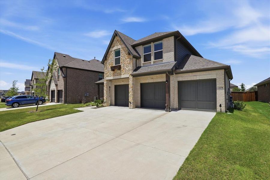 Front exterior of a new home in Valencia on The Lake, Little Elm, TX, highlighting curb appeal (Image 20).