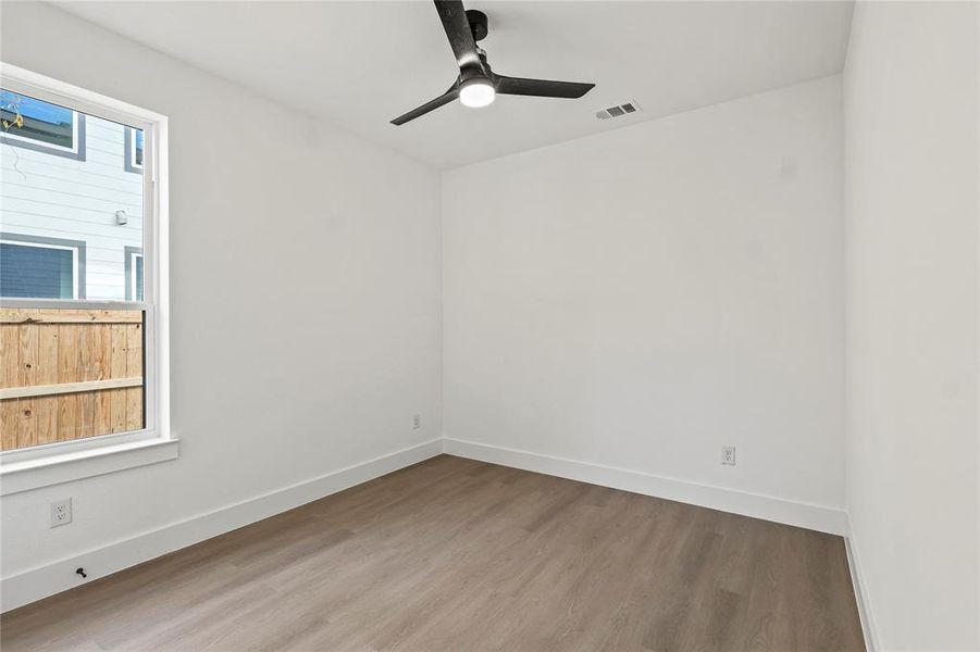 Empty room featuring hardwood / wood-style floors and ceiling fan