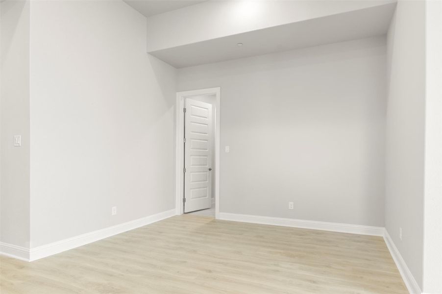 Empty room with light wood finished floors and baseboards Empty room with light wood finished floors and baseboards