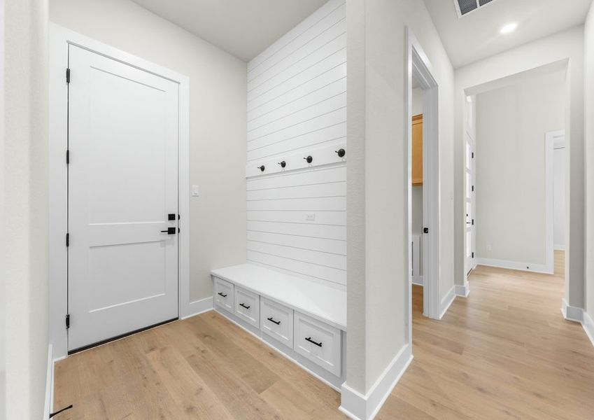 The mudroom has a great drop zone with hooks and a storage bench.