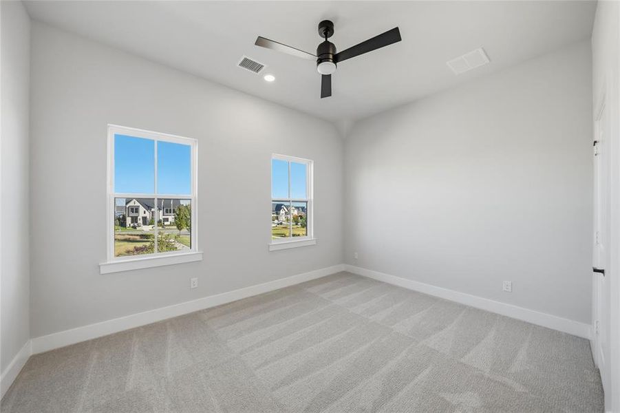Spare room featuring light carpet, recessed lighting, and ceiling fan