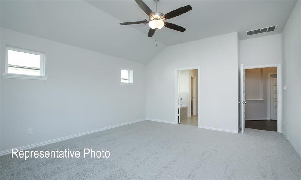 Unfurnished bedroom with light carpet, lofted ceiling, multiple windows, and ceiling fan