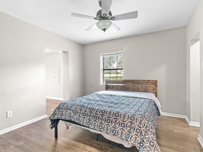 Bedroom with wood finished floors and a ceiling fan Bedroom with wood finished floors and a ceiling fan