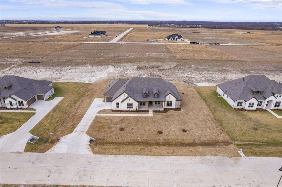 Front exterior of a new home in , Waxahachie, TX, highlighting curb appeal (Image 10).