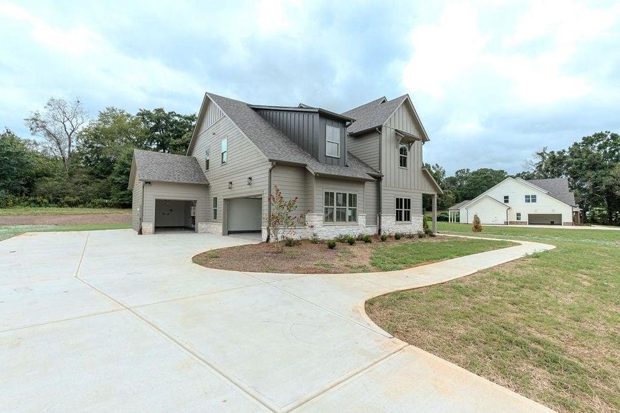 Front exterior of a new home in , Hoschton, GA, highlighting curb appeal (Image 27).