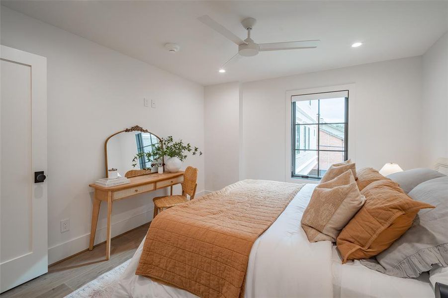 Bedroom with ceiling fan and light hardwood / wood-style floors