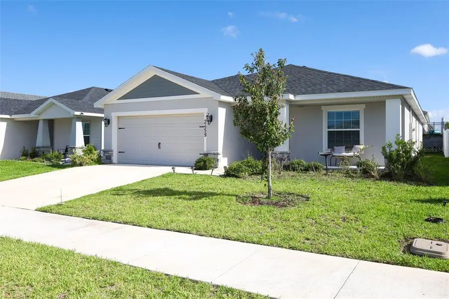Front exterior of a new home in Geneva Landings, Davenport, FL, highlighting curb appeal (Image 2). Front exterior of a new home in Geneva Landings, Davenport, FL, highlighting curb appeal (Image 2).