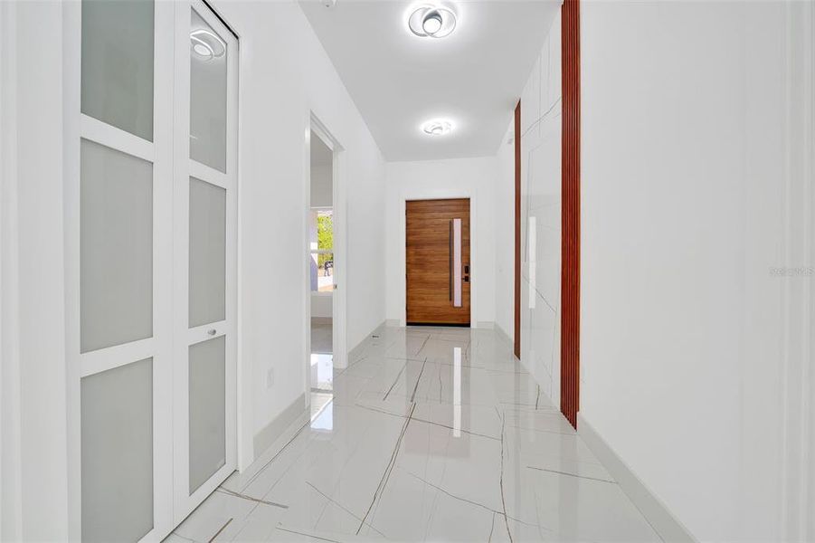 FOYER / WATERFALL OF TILE TRIMEED WITH MAHOGANY ACOUSTIC PANELS