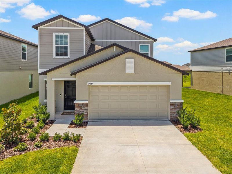 Front exterior of a new home in Prosperity Lakes, Parrish, FL, highlighting curb appeal (Image 29). Front exterior of a new home in Prosperity Lakes, Parrish, FL, highlighting curb appeal (Image 29).