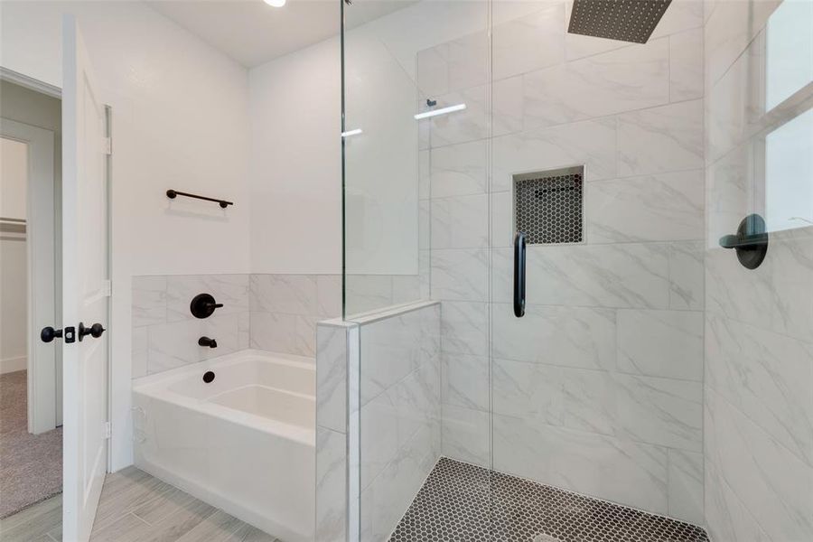 Full bath featuring a garden tub, wood finished floors, and a shower stall