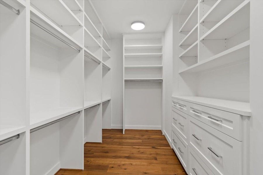 Large primary closet with his/her sides - two built in dressers on this side
