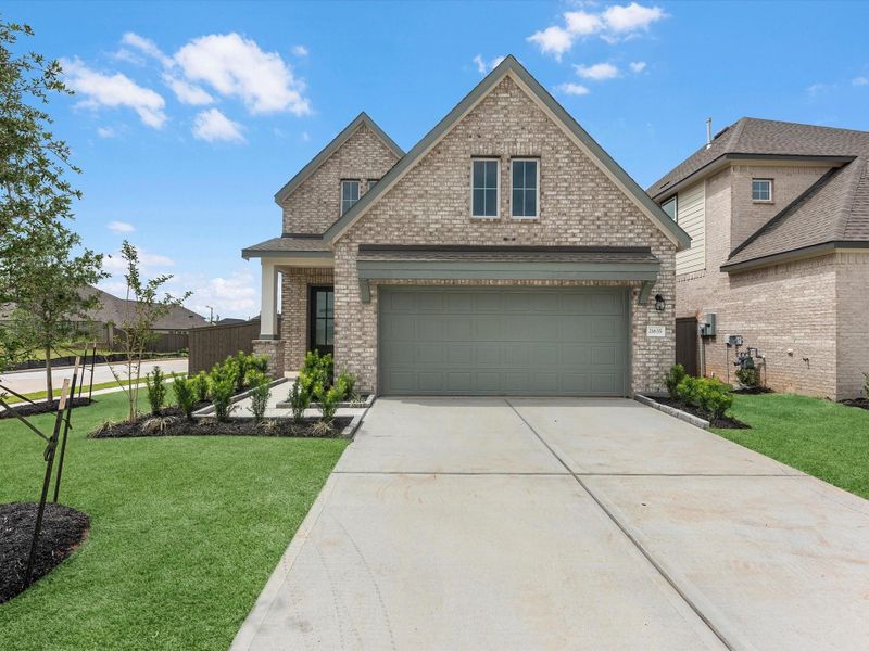 Front exterior of a new home in Emory Glen, Magnolia, TX, highlighting curb appeal (Image 2). Front exterior of a new home in Emory Glen, Magnolia, TX, highlighting curb appeal (Image 2).