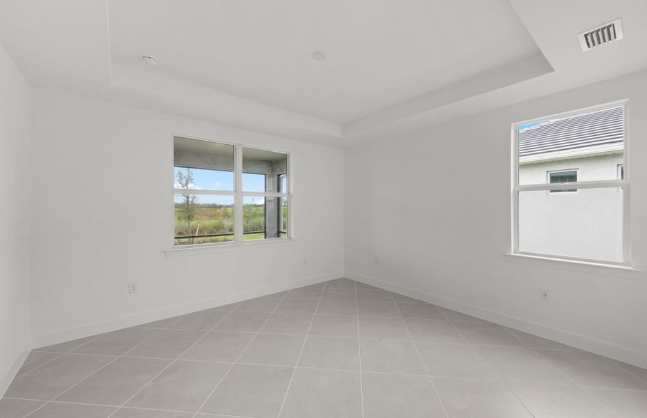 Owner's suite featuring a drop tray ceiling Owner's suite featuring a drop tray ceiling