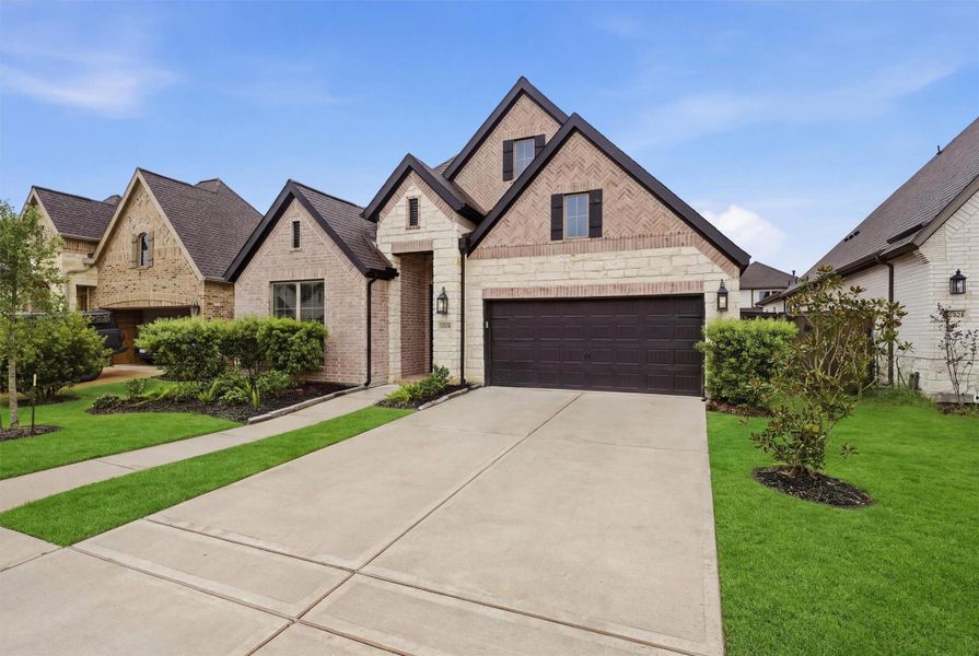 Front exterior of a new home in Riceland, Mont Belvieu, TX, highlighting curb appeal (Image 2). Front exterior of a new home in Riceland, Mont Belvieu, TX, highlighting curb appeal (Image 2).