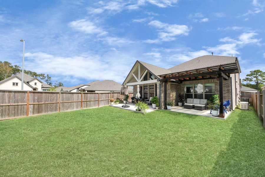 Expansive backyard with covered patio and pergola—